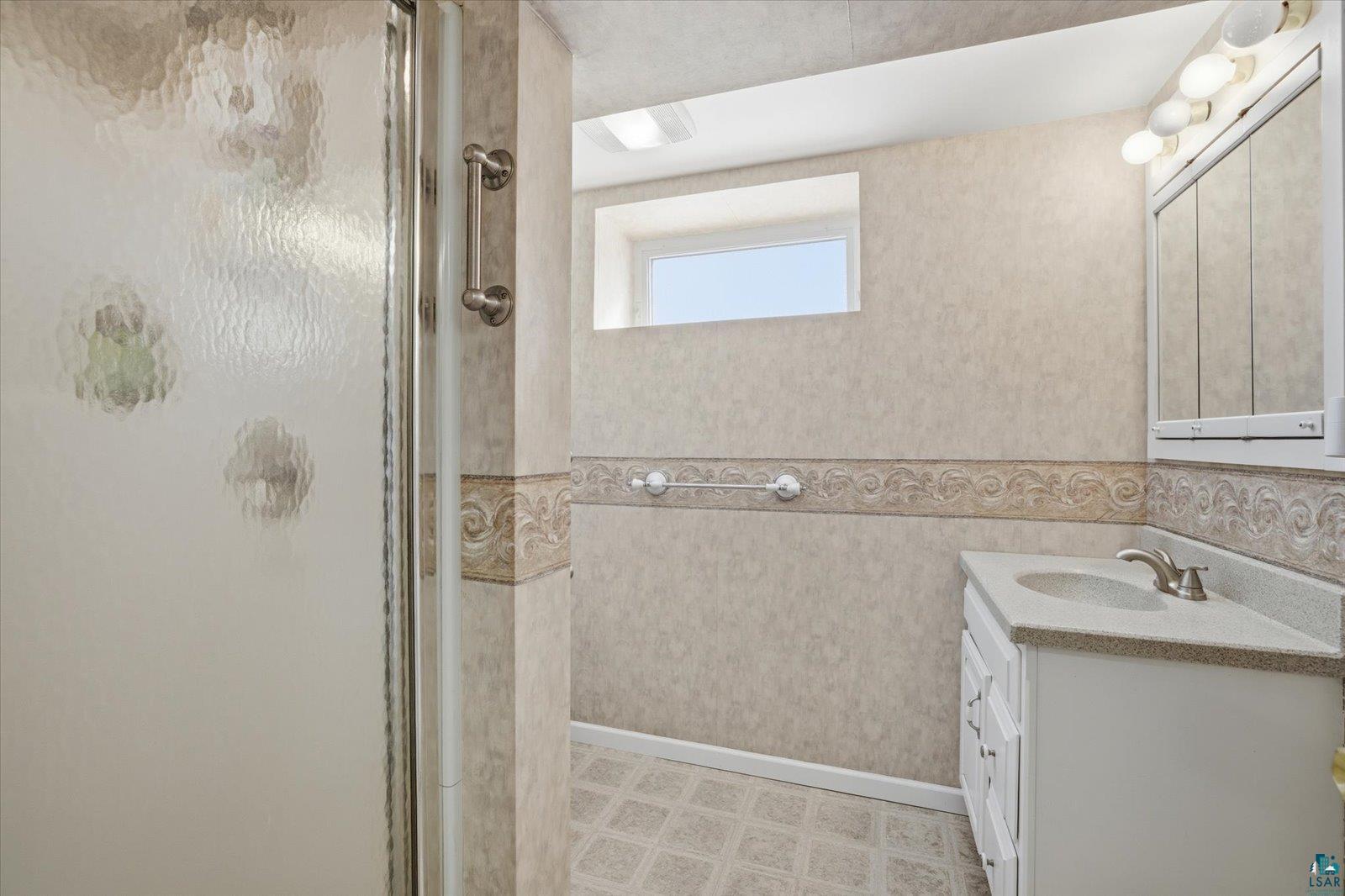 2201 Vermilion Road Duluth, MN 55803 - Photo 45 of 79 Bathroom with a stall shower, vanity, and light flooring