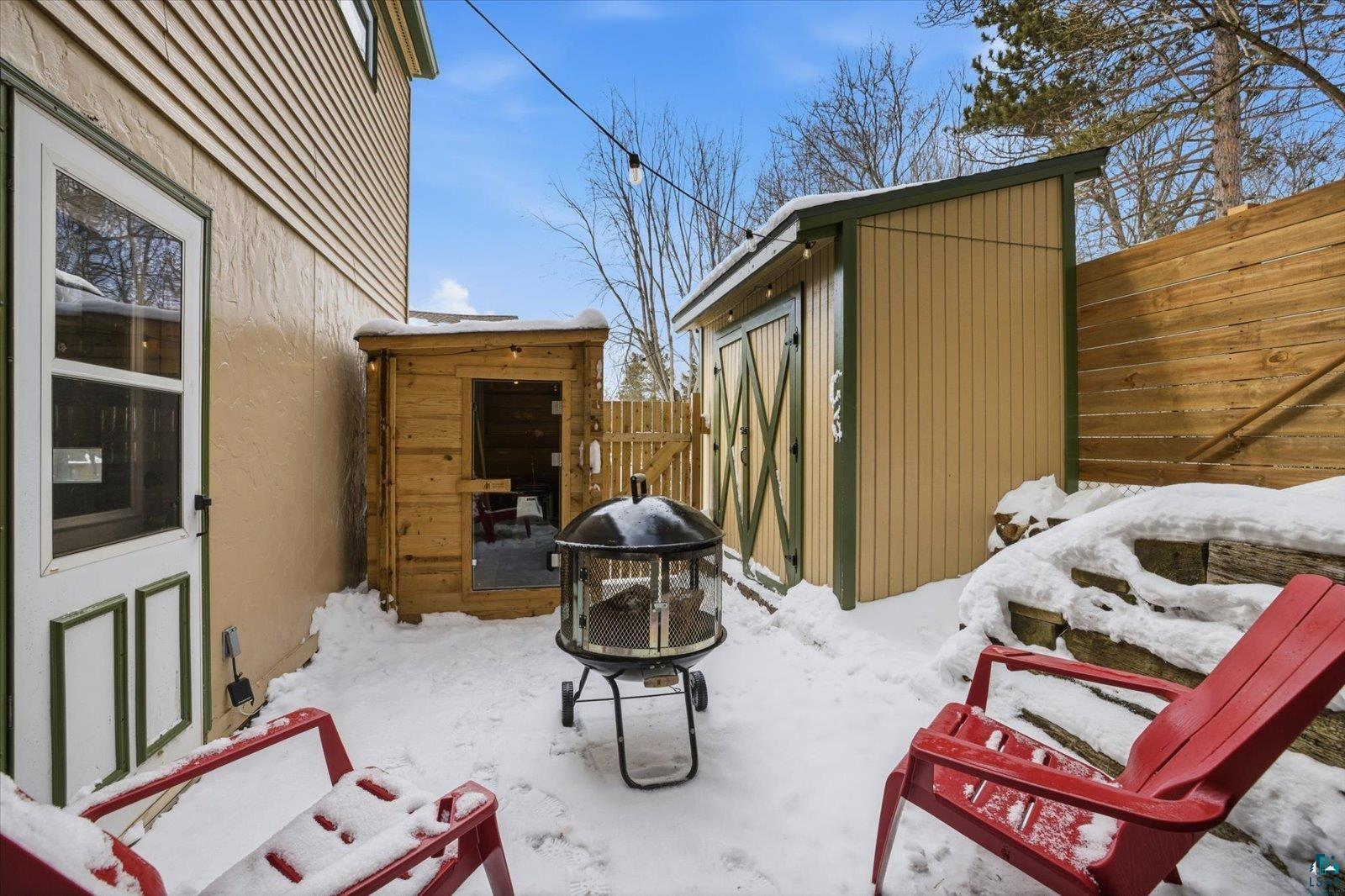 2201 Vermilion Road Duluth, MN 55803 - Photo 54 of 79 View of patio with a storage unit and an outdoor fire pit