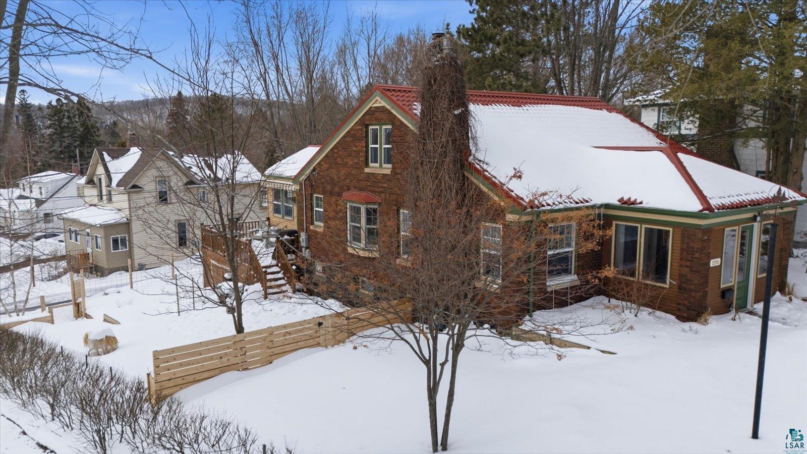2201 Vermilion Road Duluth, MN 55803 - Photo 64 of 79 View of snow covered exterior with a chimney and a deck
