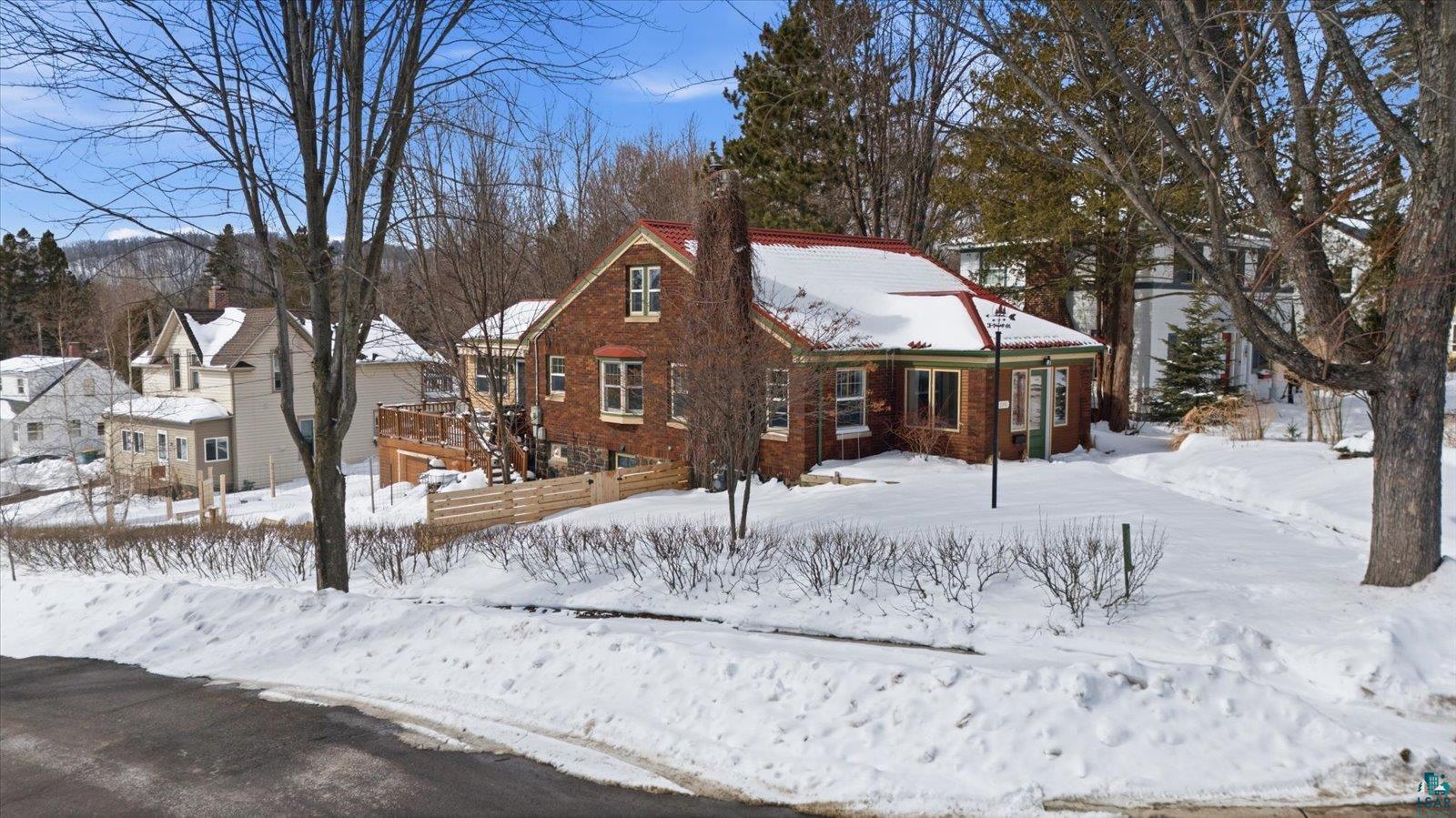 2201 Vermilion Road Duluth, MN 55803 - Photo 67 of 79 View of front of property featuring brick siding, a residential view, and a chimney