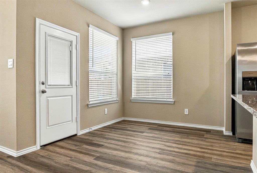 15932 Stableford Road Justin, TX 76247 - Photo 13 of 35 Wood-finish flooring with neutral wall paint