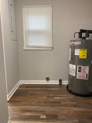 a view of a room with wooden floor and cabinet
