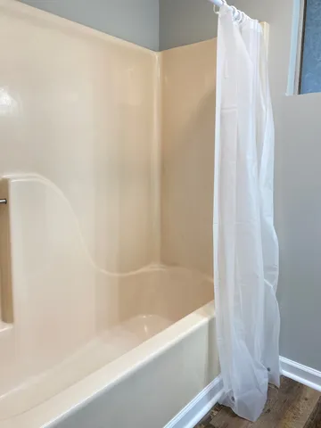a bathroom with a bathtub and a shower