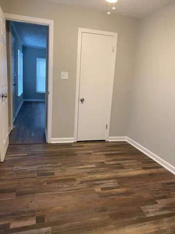 a view of a room with wooden floor