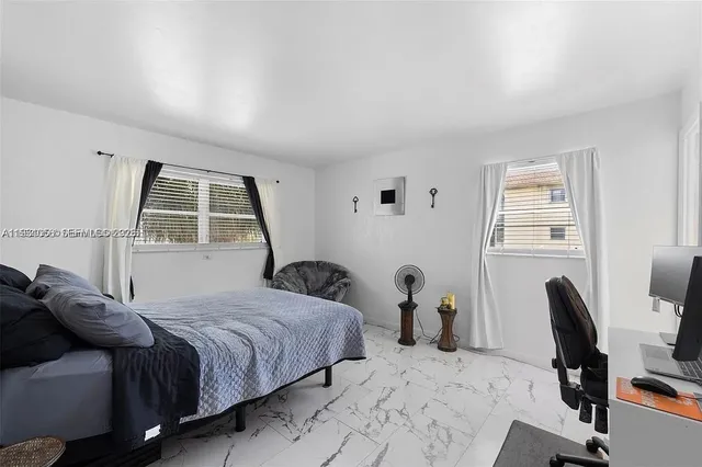 a bedroom with a bed and a chair