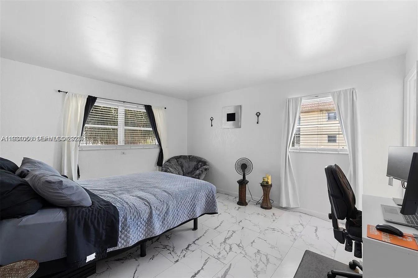 4043 Northwest 16th Street, Unit 201 Lauderhill, FL 33313 - Photo 12 of 22 a bedroom with a bed and a chair