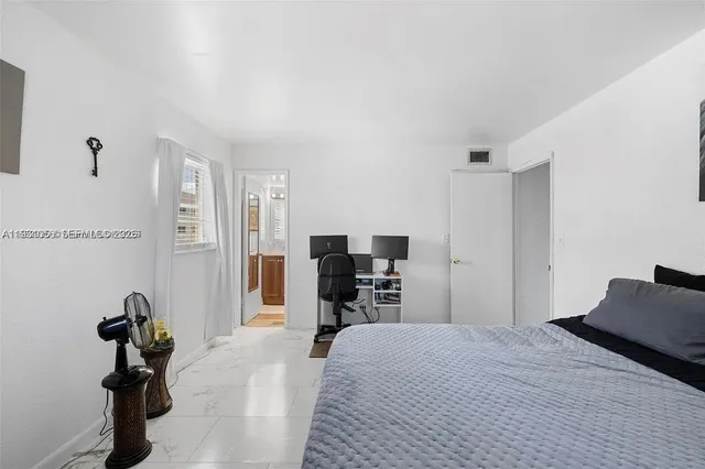 a bed room with a bed and a television