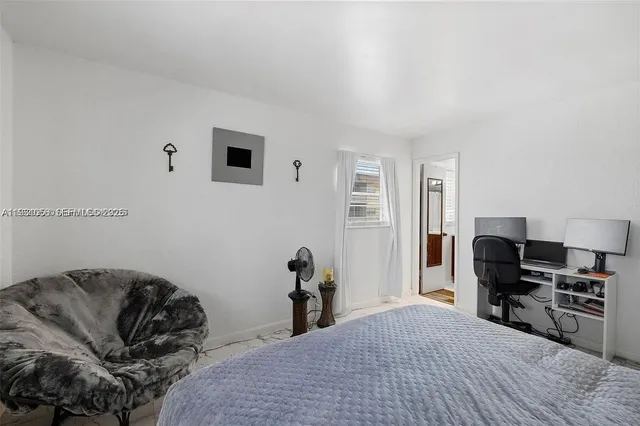 a bedroom with a bed and a piano