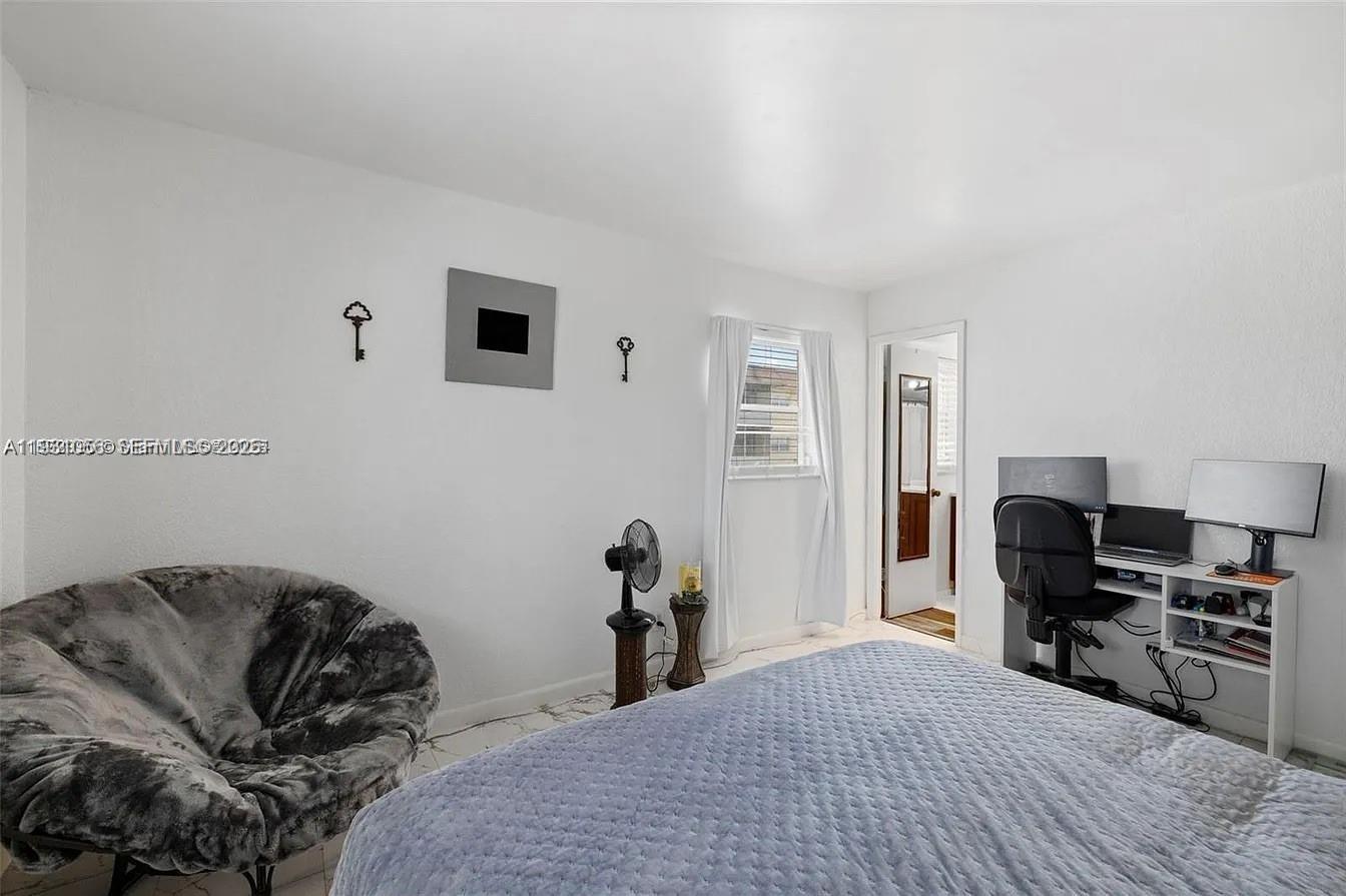 4043 Northwest 16th Street, Unit 201 Lauderhill, FL 33313 - Photo 14 of 22 a bedroom with a bed and a piano