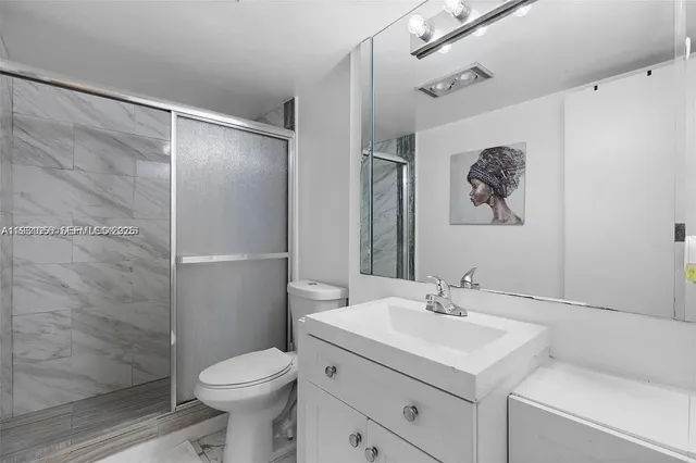 a bathroom with a sink toilet and shower