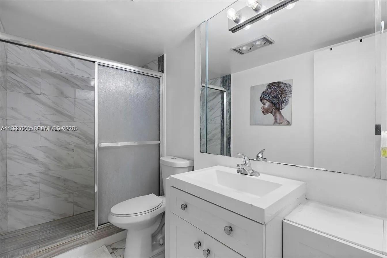 4043 Northwest 16th Street, Unit 201 Lauderhill, FL 33313 - Photo 15 of 22 a bathroom with a sink toilet and shower