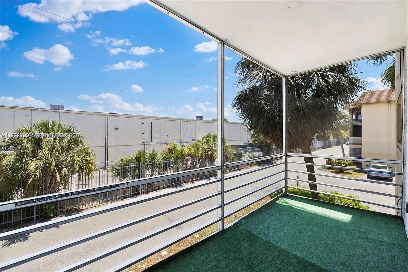 4043 Northwest 16th Street, Unit 201 Lauderhill, FL 33313 - Photo 19 of 22 a view of a building and car parked