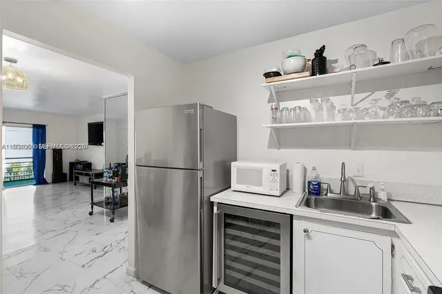 a kitchen with refrigerator cabinets and furniture