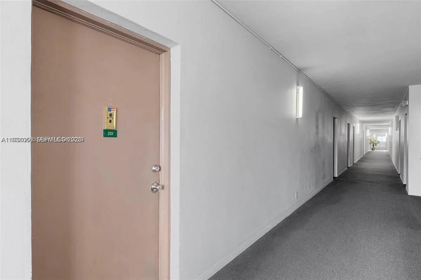 4043 Northwest 16th Street, Unit 201 Lauderhill, FL 33313 - Photo 22 of 22 a view of a hallway with wooden floor