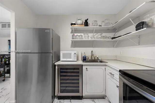 a kitchen with stainless steel appliances a refrigerator and a sink