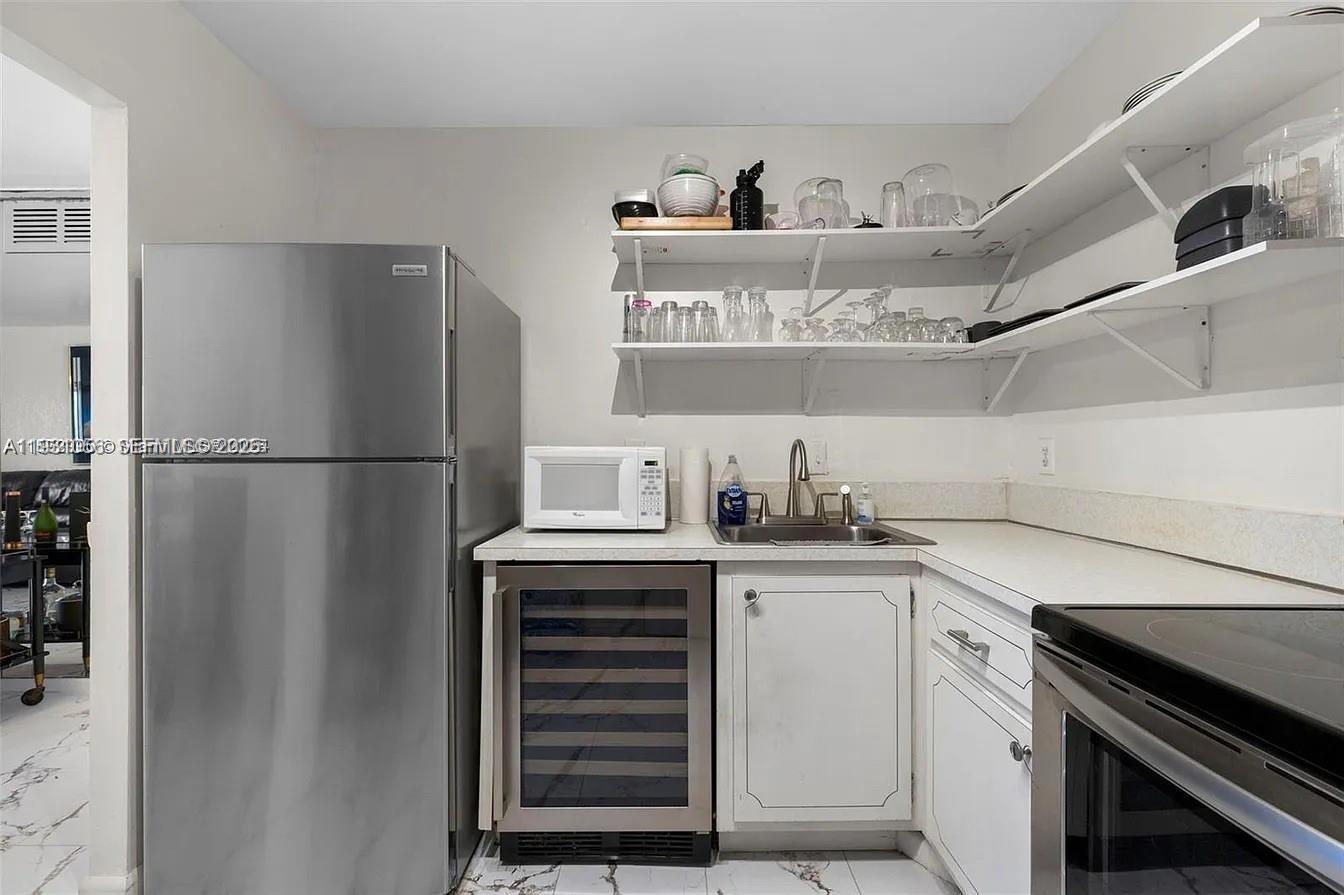 4043 Northwest 16th Street, Unit 201 Lauderhill, FL 33313 - Photo 3 of 22 a kitchen with stainless steel appliances a refrigerator and a sink