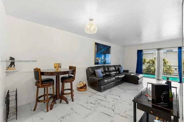 a living room with furniture a table and a large window