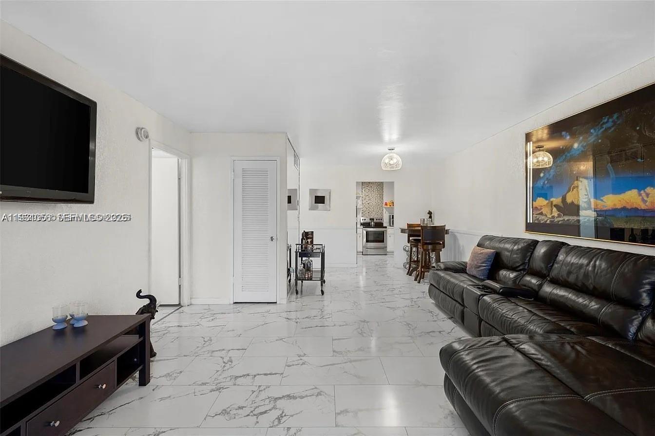 4043 Northwest 16th Street, Unit 201 Lauderhill, FL 33313 - Photo 7 of 22 a living room with furniture and a flat screen tv