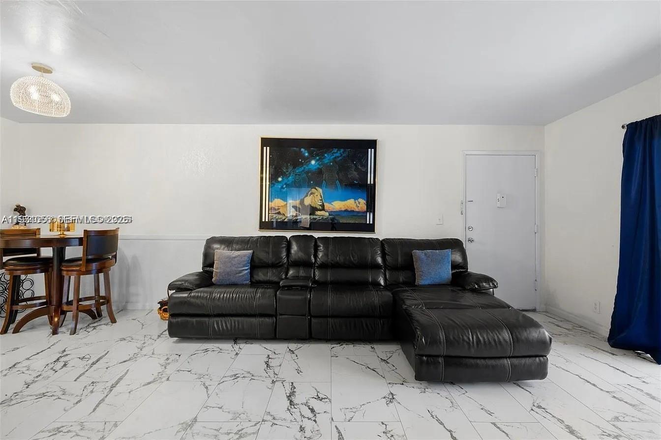 4043 Northwest 16th Street, Unit 201 Lauderhill, FL 33313 - Photo 9 of 22 a living room with furniture and a window