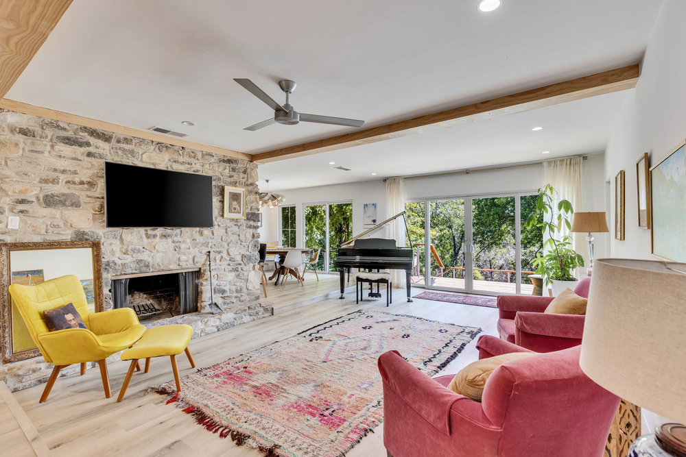 a living room with furniture a fireplace and a flat screen tv