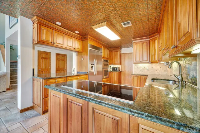 a view of a kitchen with a sink and cabinets
