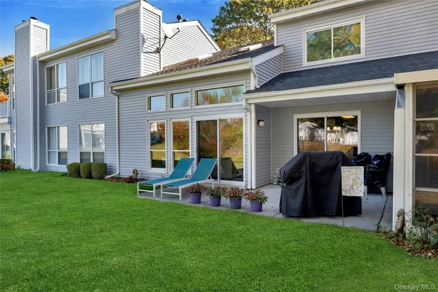 a view of a house with a backyard and a patio