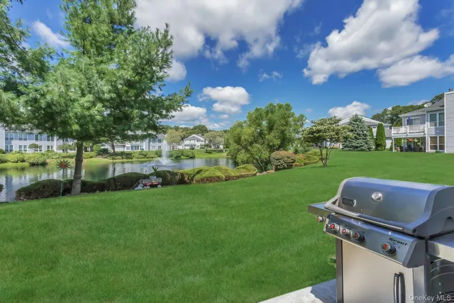 a front view of a house with garden and trees