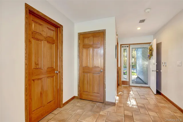 a view of a hallway with wooden shelves