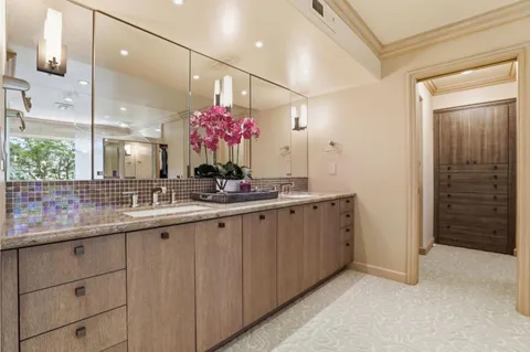 a bathroom with a sink vanity and mirror