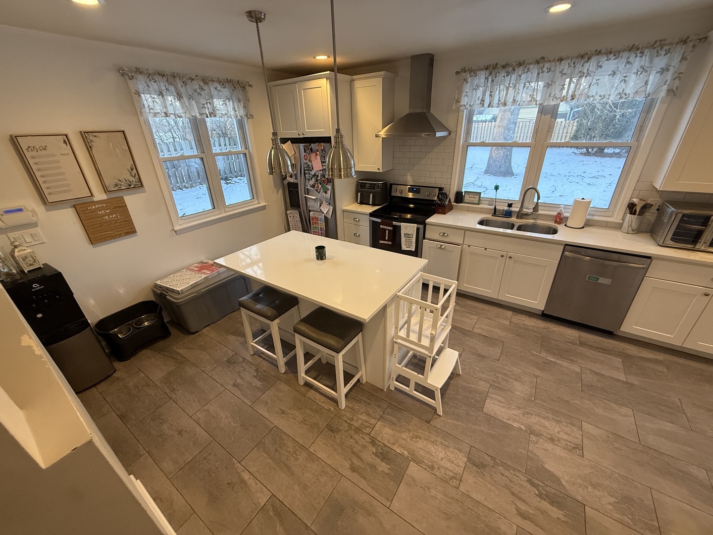 1044 Ellsworth Avenue Addison, IL 60101 - Photo 17 of 45 a kitchen with a table chairs stove and refrigerator