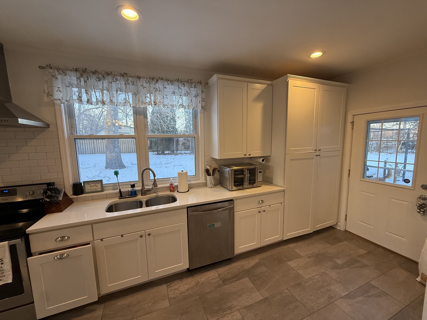1044 Ellsworth Avenue Addison, IL 60101 - Photo 21 of 45 a kitchen with white cabinets and sink