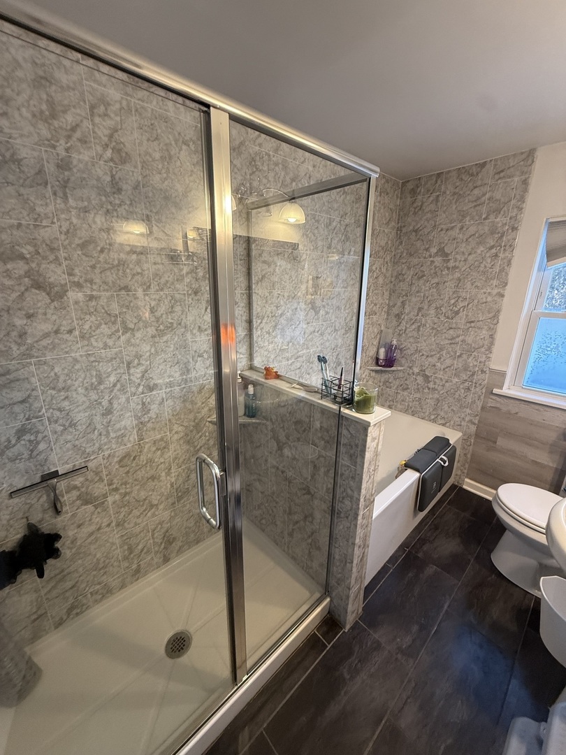 1044 Ellsworth Avenue Addison, IL 60101 - Photo 36 of 45 a bathroom with a bathtub and a shower
