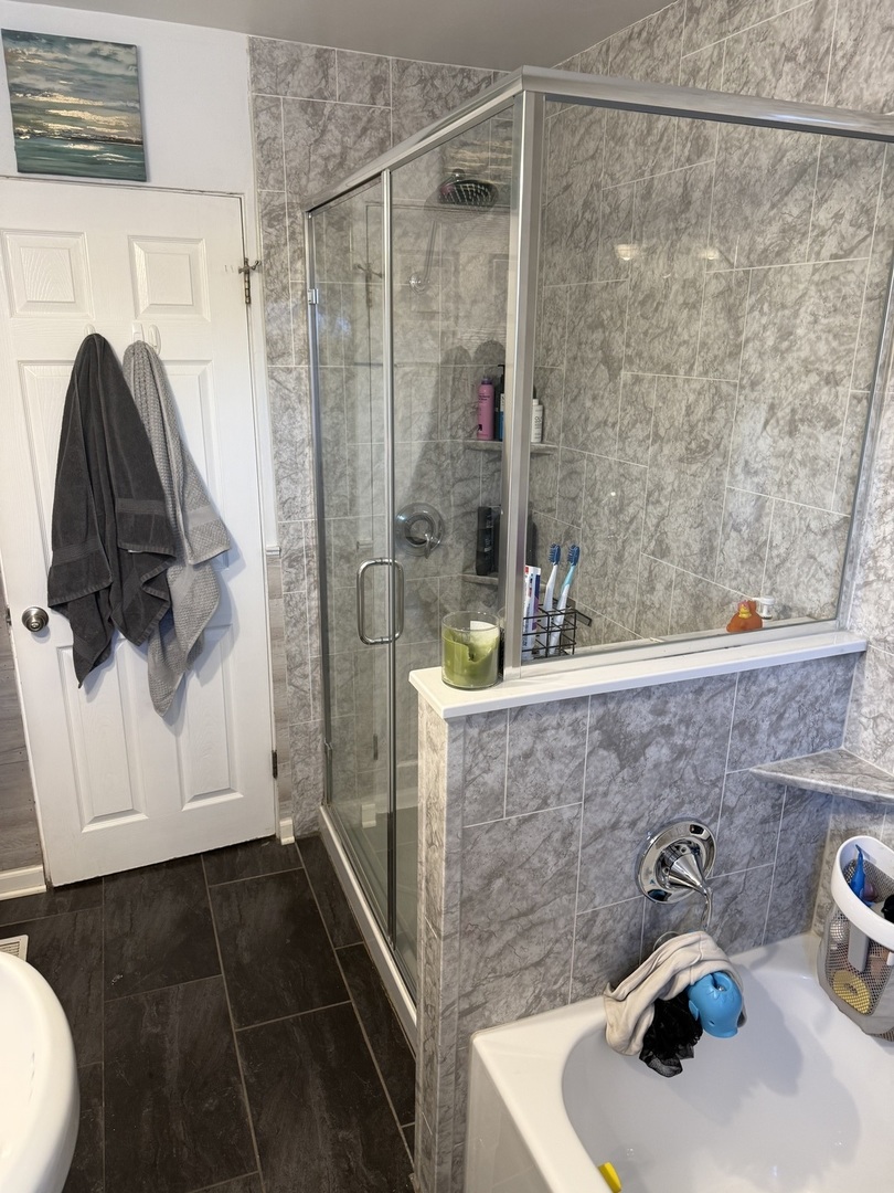 1044 Ellsworth Avenue Addison, IL 60101 - Photo 37 of 45 a bathroom with a sink and a shower