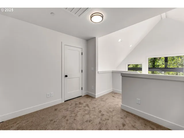 view of an empty room and kitchen