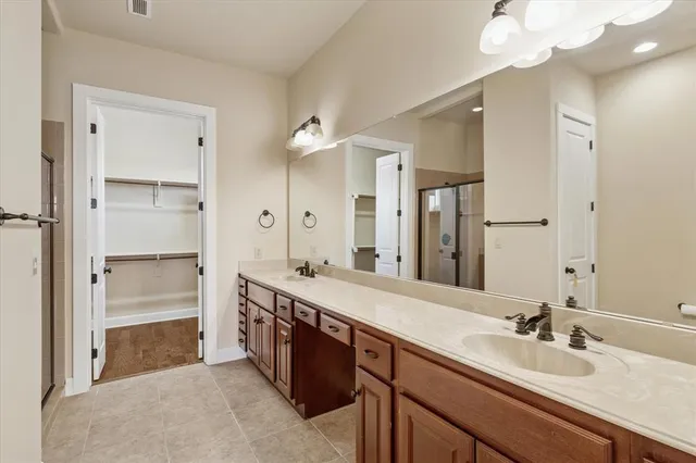 a spacious bathroom with a double vanity sink mirror and double