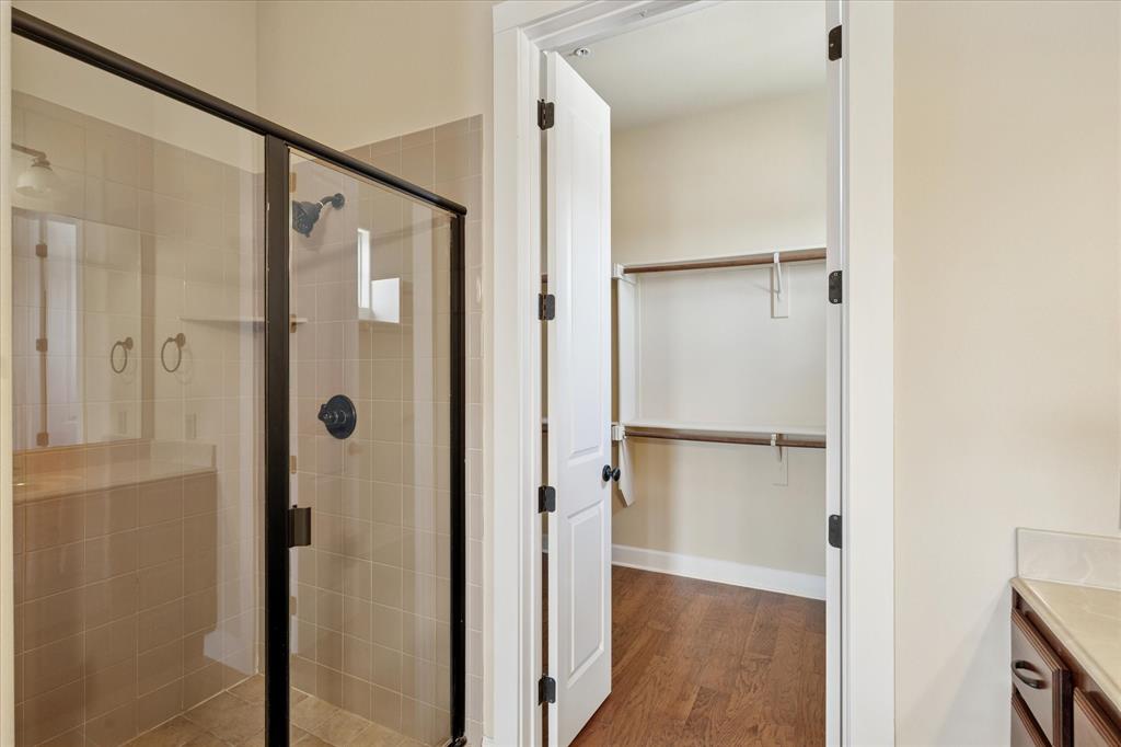 610 Via Ravello, Unit 410 Irving, TX 75039 - Photo 15 of 28 a bathroom with a glass shower door