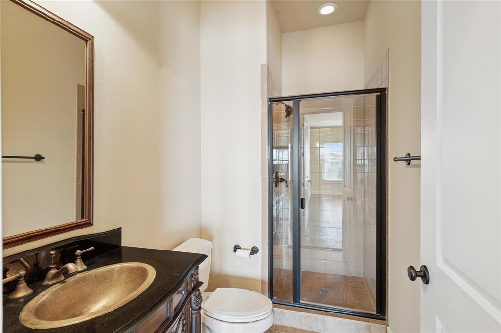 610 Via Ravello, Unit 410 Irving, TX 75039 - Photo 18 of 28 a bathroom with a sink toilet and shower
