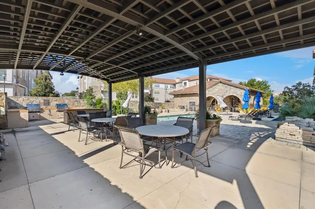 a view of a dinning table and chairs in the patio