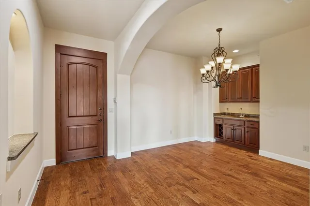 a view of a kitchen with a sink and dishwasher wooden floor