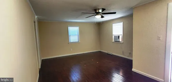 a view of a livingroom with a hardwood floor and a ceiling fan