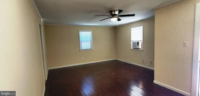 a view of a livingroom with a hardwood floor and a ceiling fan