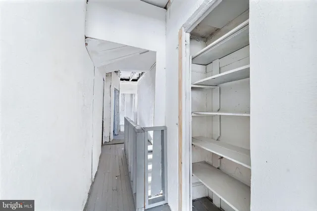 a view of a walk in closet with empty racks