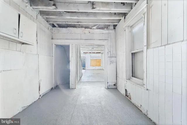 a view of a hallway with wooden shelves