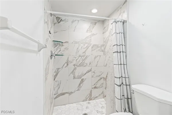 a bathroom with a shower curtain and a toilet