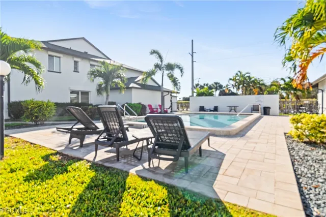 a view of a swimming pool with outdoor seating