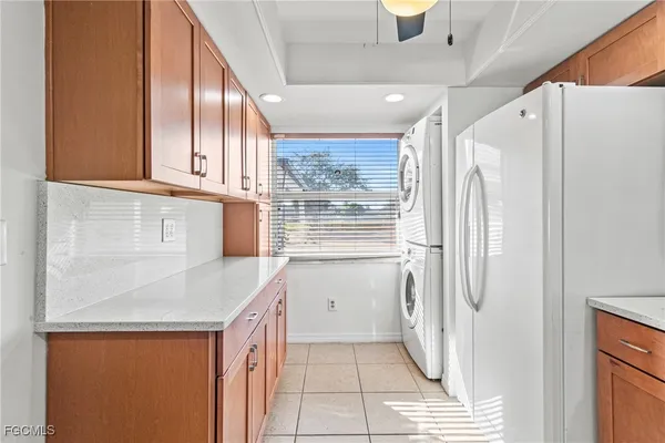a kitchen with a refrigerator a sink and cabinets