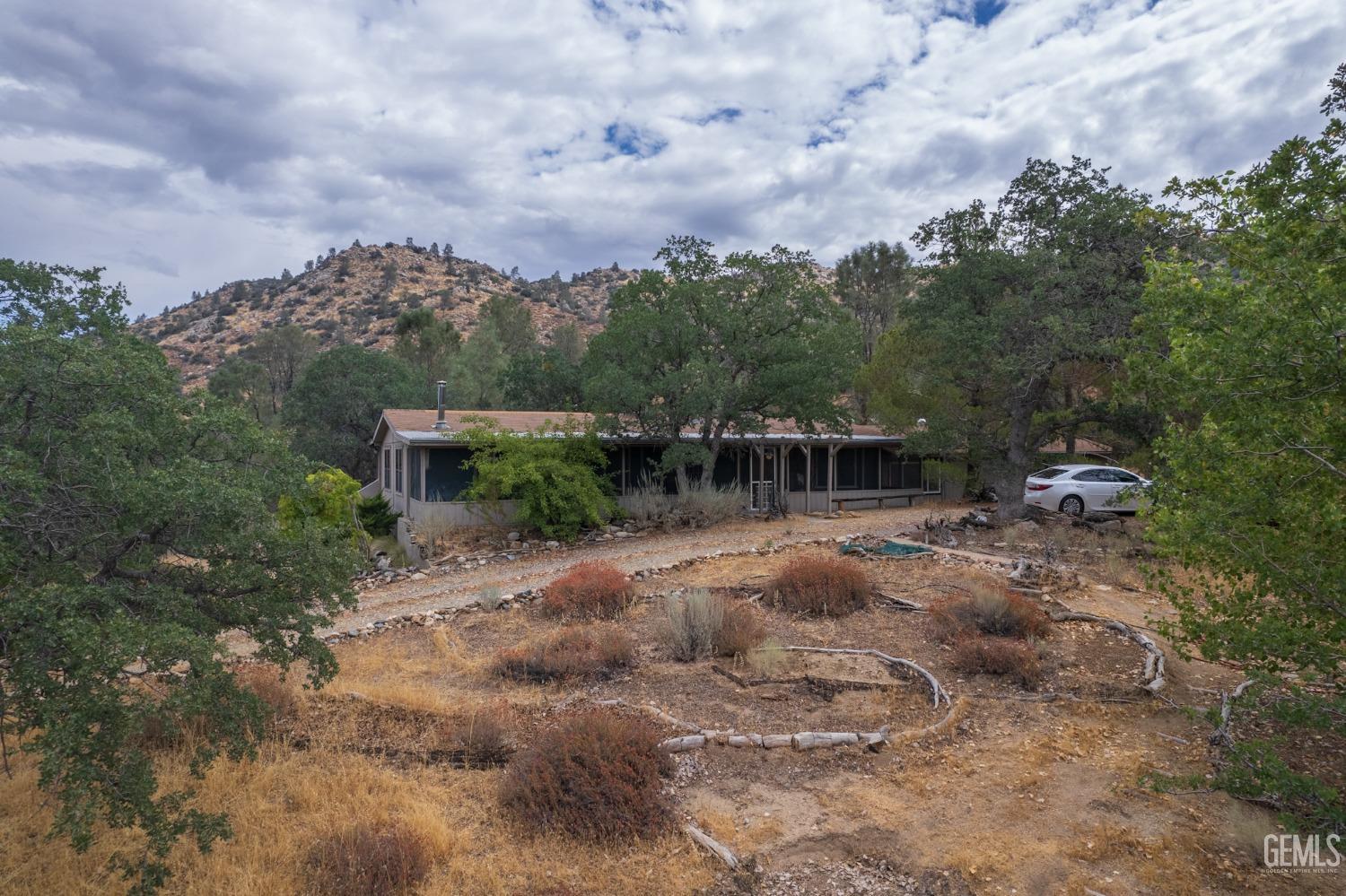 Undisclosed Address Caliente, CA 93518 - Photo 22 of 38 a view of a yard with plants and a lake view