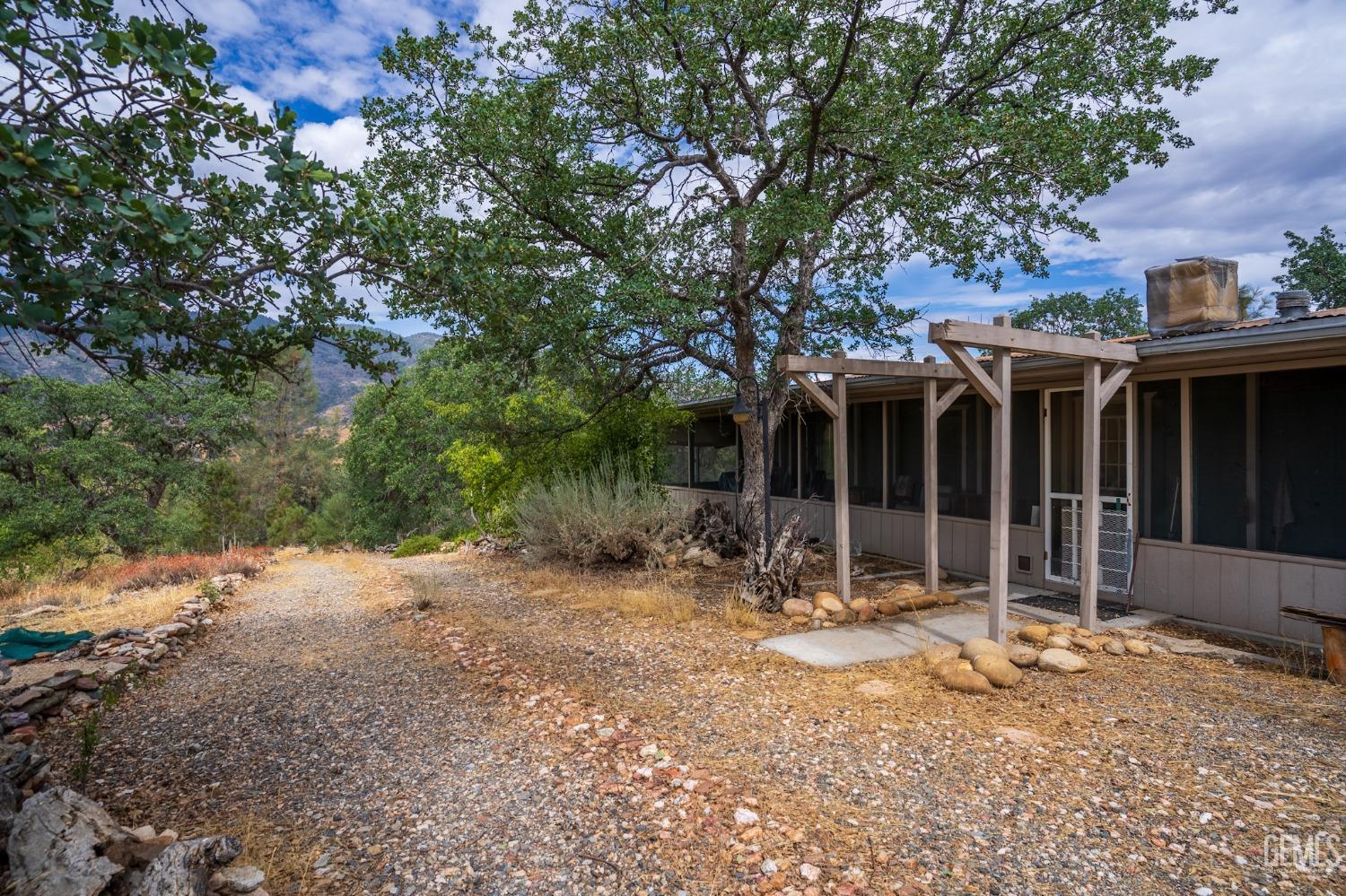 Undisclosed Address Caliente, CA 93518 - Photo 28 of 38 a backyard of a house with basket ball court and outdoor seating