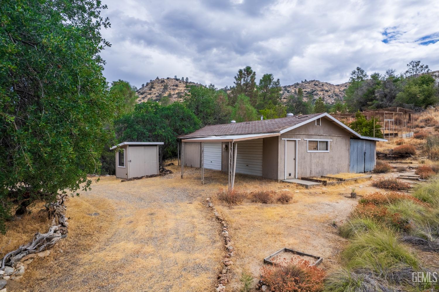 Undisclosed Address Caliente, CA 93518 - Photo 3 of 38 a view of a house with wooden fence and a big yard