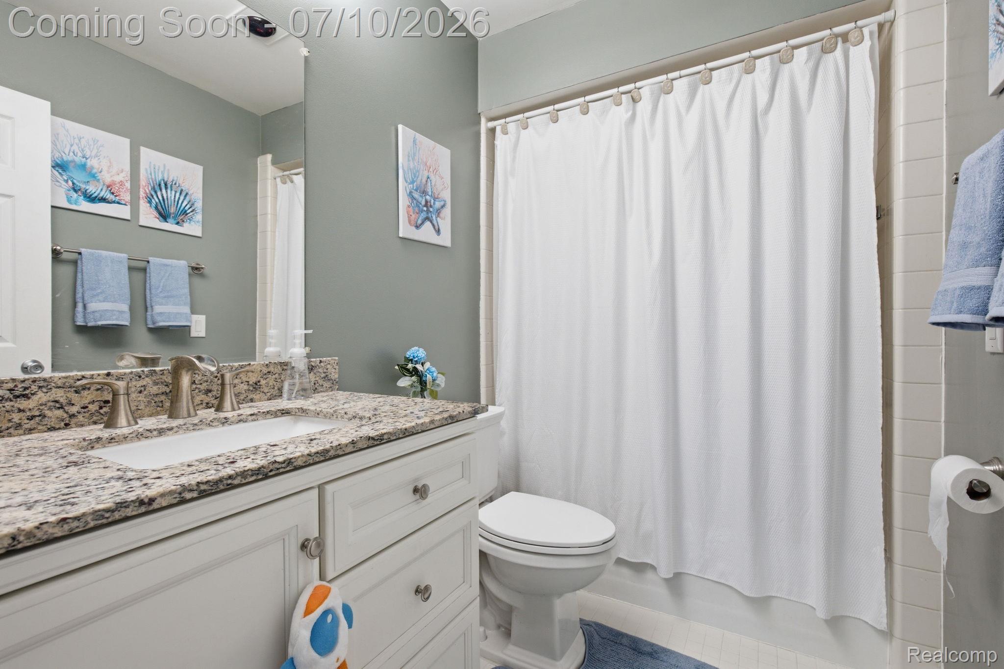 1501 River Road, Unit 301 St. Clair, MI 48079 - Photo 26 of 32 Bathroom featuring a white vanity with granite countertop, undermount sink, and brushed nickel fixtures